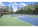 Tennis courts with trees surrounding them in a community complex at 1721 Mulberry Lake Dr, Dacula, GA 30019