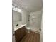 Bathroom featuring new vanity, toilet, and shower with tiled walls at 2041 Olive Springs Rd, Marietta, GA 30060