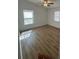 This bedroom features wood-look floors, bright natural light and a ceiling fan at 2041 Olive Springs Rd, Marietta, GA 30060