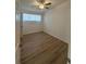This bedroom features wood-look floors, bright natural light and a ceiling fan at 2041 Olive Springs Rd, Marietta, GA 30060