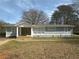 Charming single story home featuring neutral gray tones and manicured front yard at 2041 Olive Springs Rd, Marietta, GA 30060