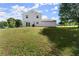 A spacious, grassy backyard with a two-story home and a partial view of the property's exterior at 282 Oak Rdg, Auburn, GA 30011