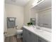 This bathroom features a grey vanity, a white sink, and tile flooring at 282 Oak Rdg, Auburn, GA 30011