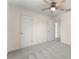 Bedroom featuring a ceiling fan, neutral paint, carpet, and two doors at 282 Oak Rdg, Auburn, GA 30011