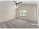 A carpeted room with a ceiling fan and a window to the outside at 282 Oak Rdg, Auburn, GA 30011
