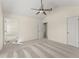 Spacious carpeted bedroom features ensuite bathroom, ceiling fan, and closet at 282 Oak Rdg, Auburn, GA 30011