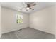 Bedroom featuring a ceiling fan, neutral paint, carpet, and a window at 282 Oak Rdg, Auburn, GA 30011