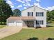 Charming two-story home featuring a spacious three-car garage and welcoming stone-accented entryway at 282 Oak Rdg, Auburn, GA 30011