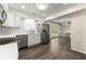 Modern kitchen with stainless steel appliances, white cabinets, and hardwood floors at 282 Oak Rdg, Auburn, GA 30011