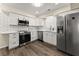 Modern kitchen featuring stainless steel appliances, white cabinetry, and subway tile backsplash at 282 Oak Rdg, Auburn, GA 30011