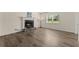 Cozy living room featuring a fireplace, new flooring, and natural light at 282 Oak Rdg, Auburn, GA 30011