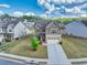 Aerial view of a two-story home with a manicured front yard and a paved driveway in a suburban setting at 3477 Ivy Birch Way, Buford, GA 30519