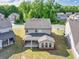 Aerial view of the home's backyard featuring a covered patio and a large grassy area at 3477 Ivy Birch Way, Buford, GA 30519