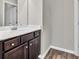 Bathroom featuring a granite countertop and dark brown cabinets at 3477 Ivy Birch Way, Buford, GA 30519