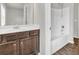Bathroom with wood floors, granite countertop and shower-tub combo with white shower surround at 3477 Ivy Birch Way, Buford, GA 30519