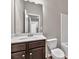 Bathroom featuring a single sink vanity with modern fixtures and a neutral color scheme at 3477 Ivy Birch Way, Buford, GA 30519