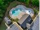 Aerial view of the community pool and clubhouse surrounded by trees and parking at 3477 Ivy Birch Way, Buford, GA 30519