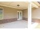 Covered patio with white columns and double doors leading into the home at 3477 Ivy Birch Way, Buford, GA 30519