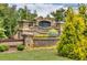 Entrance to The Village at Ivy Creek neighborhood with stone signage at 3477 Ivy Birch Way, Buford, GA 30519