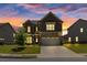Charming home exterior with a well-manicured lawn at dusk at 3477 Ivy Birch Way, Buford, GA 30519
