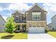 Charming two-story home with stone accents and a well-manicured lawn, perfect for curb appeal at 3477 Ivy Birch Way, Buford, GA 30519