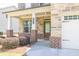Inviting covered front porch featuring stone and brick accents, a perfect spot for relaxation and greeting guests at 3477 Ivy Birch Way, Buford, GA 30519