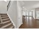 View of entry stairs leading to an open-concept living space featuring beautiful flooring and abundant natural light at 3477 Ivy Birch Way, Buford, GA 30519