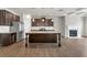 Beautiful kitchen with stainless steel appliances, granite countertops, a central island, and a cozy fireplace at 3477 Ivy Birch Way, Buford, GA 30519