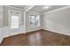 Bright living room featuring beautiful wood floors, ample natural light, and an inviting open layout. Great for gatherings at 3477 Ivy Birch Way, Buford, GA 30519