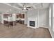 Living room featuring a fireplace, coffered ceiling, wood-look floors, and an open layout to the kitchen at 3477 Ivy Birch Way, Buford, GA 30519