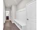 Mud room with storage bench and coat hooks, providing a tidy transition from the outside at 3477 Ivy Birch Way, Buford, GA 30519