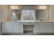 Bathroom with double vanity, white cabinets, and two large mirrors at 4032 Andover Cir, Mcdonough, GA 30252