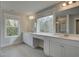 Bathroom with double vanity, tiled floor and a large window at 4032 Andover Cir, Mcdonough, GA 30252
