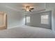 Spacious bedroom features plush carpeting, natural light, and a modern ceiling fan at 4032 Andover Cir, Mcdonough, GA 30252