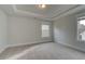 Simple bedroom with carpet and modern tray ceilings at 4032 Andover Cir, Mcdonough, GA 30252