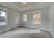 Bedroom with carpet and views through bright windows at 4032 Andover Cir, Mcdonough, GA 30252