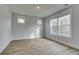 Neutral bedroom featuring hardwood floors and a set of bright windows at 4032 Andover Cir, Mcdonough, GA 30252