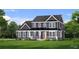 Charming two-story home with a covered porch, well manicured lawn, and beautiful landscaping at 4032 Andover Cir, Mcdonough, GA 30252