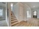 Open foyer featuring wood-look floors, staircase, and a view into the adjacent living spaces at 4032 Andover Cir, Mcdonough, GA 30252