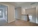 Hallway with carpet and wooden railings, with a view to the outside through the window at 4032 Andover Cir, Mcdonough, GA 30252