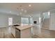 Open-concept kitchen featuring a central island, stainless steel appliances, and hardwood floors at 4032 Andover Cir, Mcdonough, GA 30252