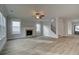 Cozy living room featuring a fireplace, hardwood floors, and open floorplan at 4032 Andover Cir, Mcdonough, GA 30252