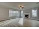 Bright living room with a fireplace, hardwood floors, and lots of windows at 4032 Andover Cir, Mcdonough, GA 30252