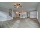 Open concept living room with hardwood floors connecting to the kitchen and dining area at 4032 Andover Cir, Mcdonough, GA 30252