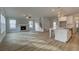 Open-concept living space with a fireplace, adjacent kitchen, and beautiful flooring at 4032 Andover Cir, Mcdonough, GA 30252