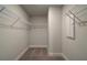Small walk-in closet with wire shelving and neutral carpeting at 4032 Andover Cir, Mcdonough, GA 30252
