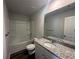 Bathroom featuring granite countertops, modern fixtures, and a shower-tub combo at 8666 Webb Rd, Riverdale, GA 30274