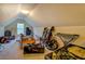 View of carpeted attic space with slanted ceilings and a window providing natural light at 265 Oak Hill Dr, Covington, GA 30016