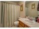 Cozy bathroom with a shower-tub combo, decorated with palm tree art and a single vanity at 265 Oak Hill Dr, Covington, GA 30016