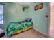 This cozy bedroom showcases a twin bed with a modern fan and nature-inspired decor at 265 Oak Hill Dr, Covington, GA 30016